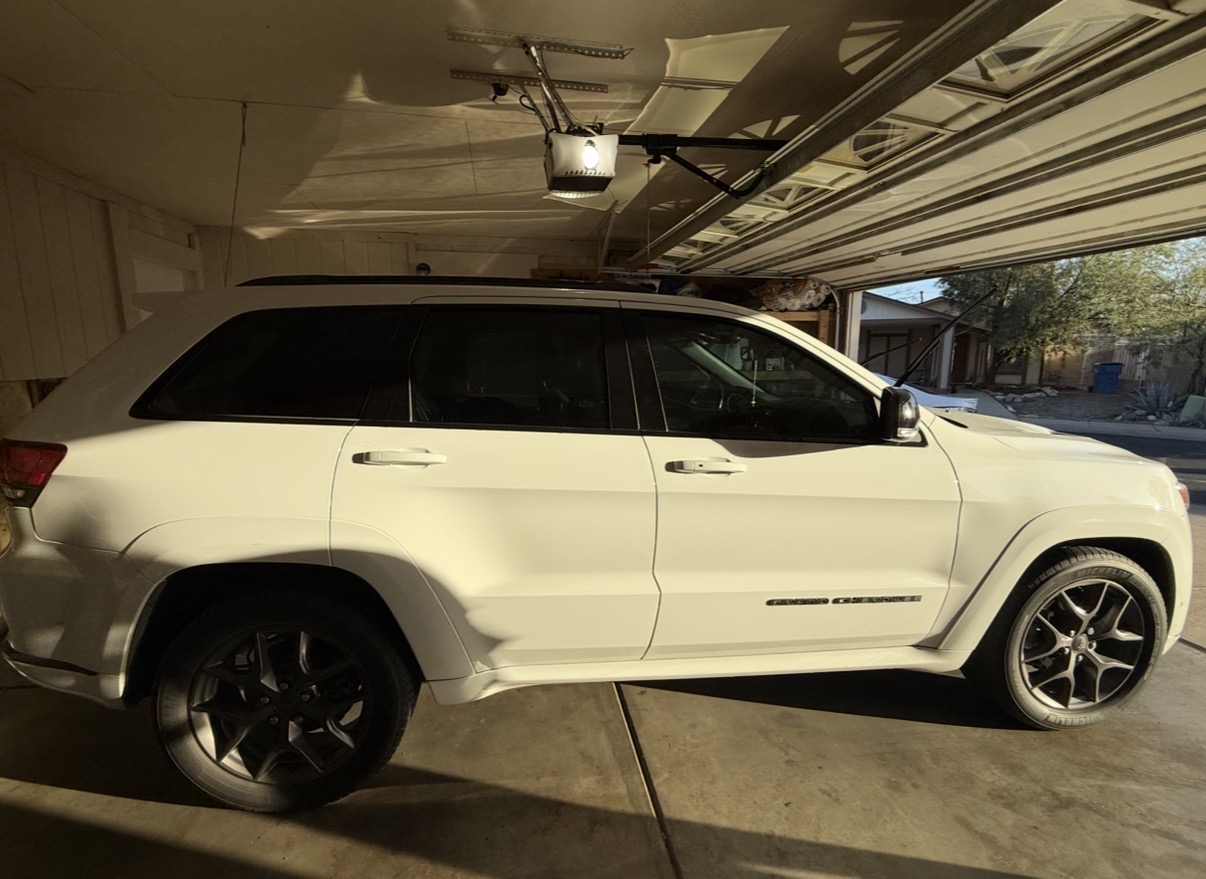 White Jeep Grand Cherokee with full tint